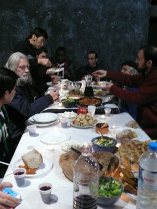 Figure 2. A communal Christmas meal in 2013 taking place in the stage of the theater . Photograph by Eleni Tzirtzilaki.
